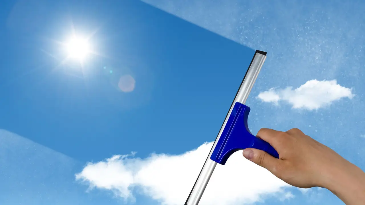 A squeegee against a clear blue sky — request your free window cleaning quote