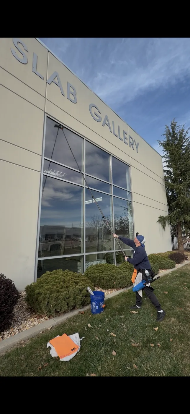 Cleaning the storefront glass of a Boise commercial building