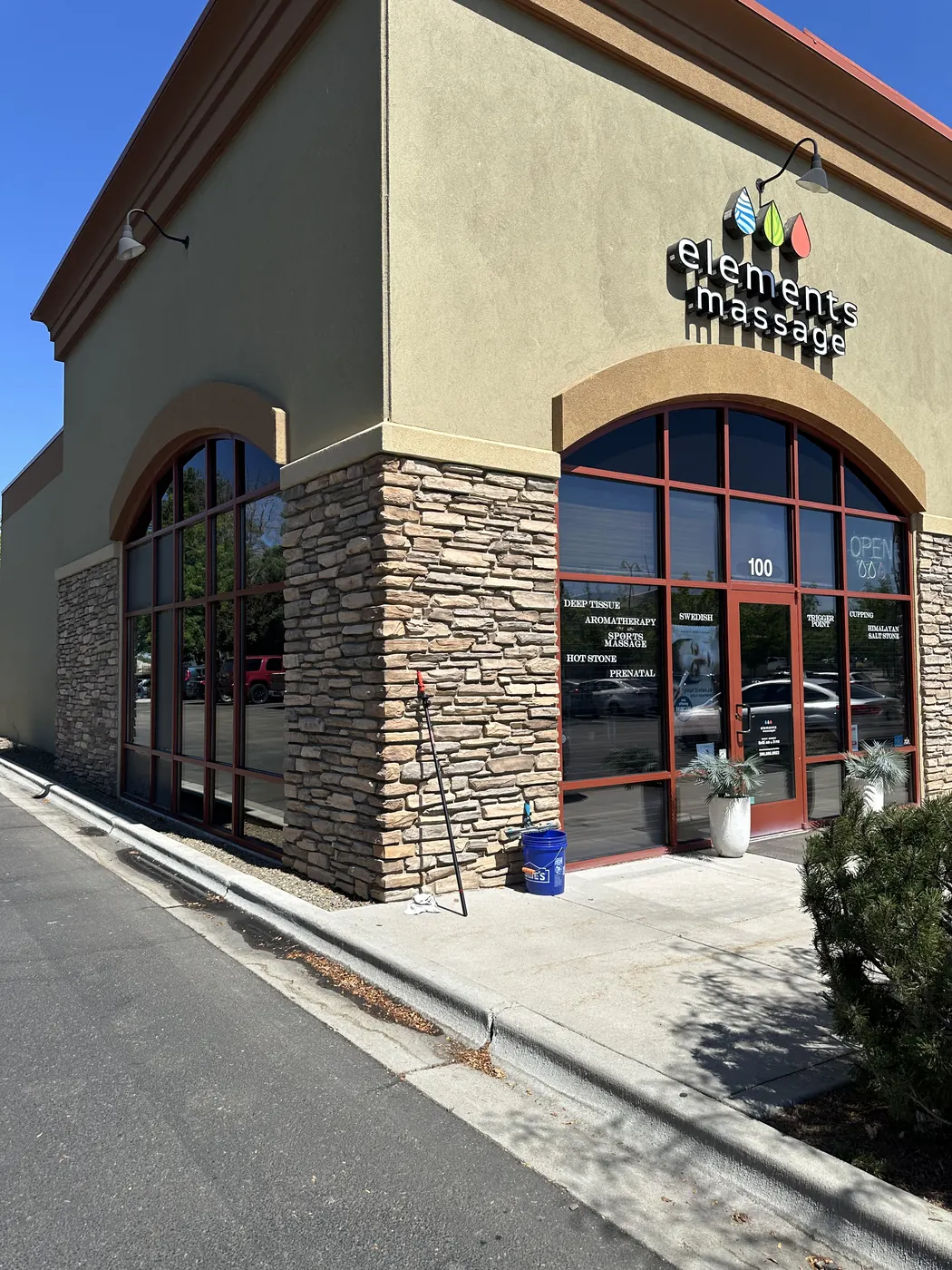 Stucco-and-stone storefront with spotless glass after professional window cleaning