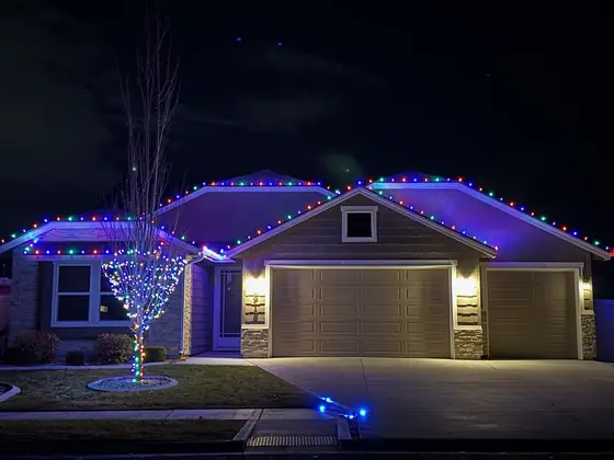Custom Christmas lights installed along a Boise rooftop at night