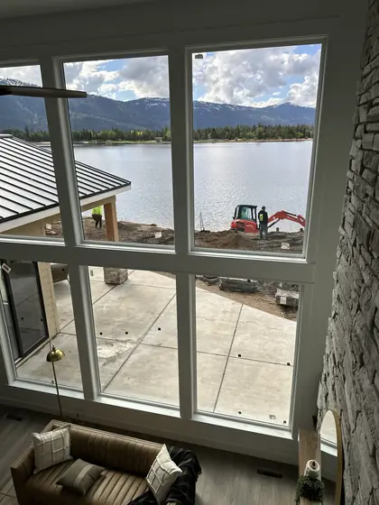 Clean glass opening onto a lakeside patio