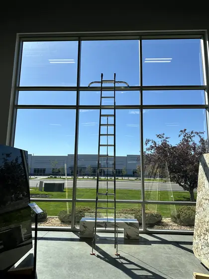 Cleaning tall interior windows from a ladder